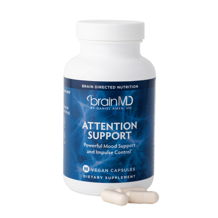 BrainMD Attention Support: supplement bottle with sample capsules in front of a transparent background