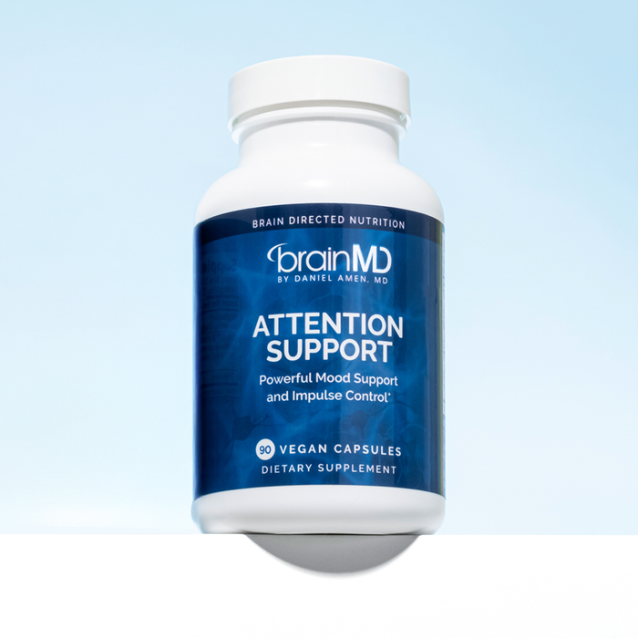 Blue supplement bottle against a light blue background.