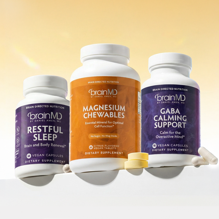 1 large orange supplement bottle and 2 small purple supplement bottles against a yellow background.