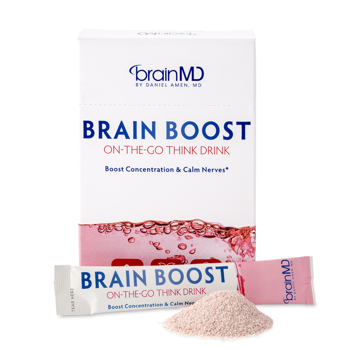 BrainMD Brain Boost On-The-Go: pink and white supplement box, packet and powder at the base, against a transparent background