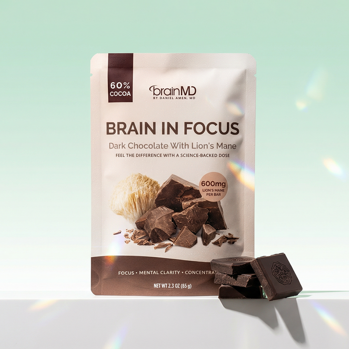 Brown chocolate bar package with chocolate squares at the base against a mint green background.