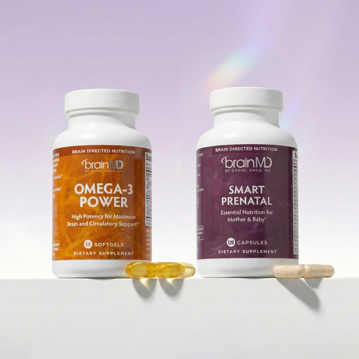 Two supplement bottles labeled 'Omega-3 Power' and 'Smart Prenatal' by BrainMD on a white surface with a purple gradient background.