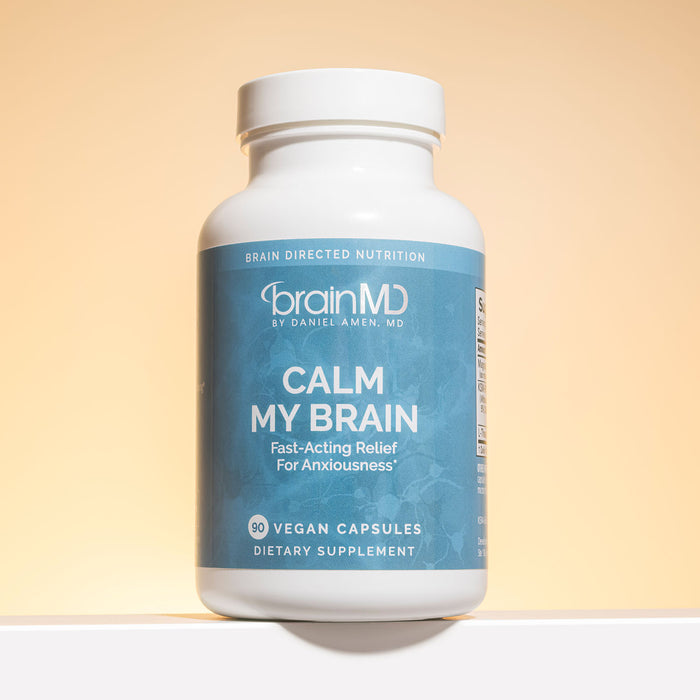 Light blue supplement bottle against a light yellow background.
