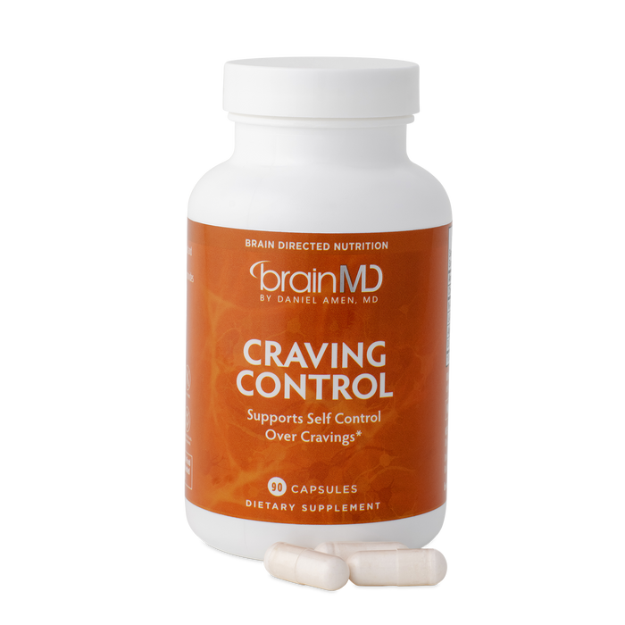 BrainMD Craving Control: orange supplement bottle with capsules at the base against a transparent background