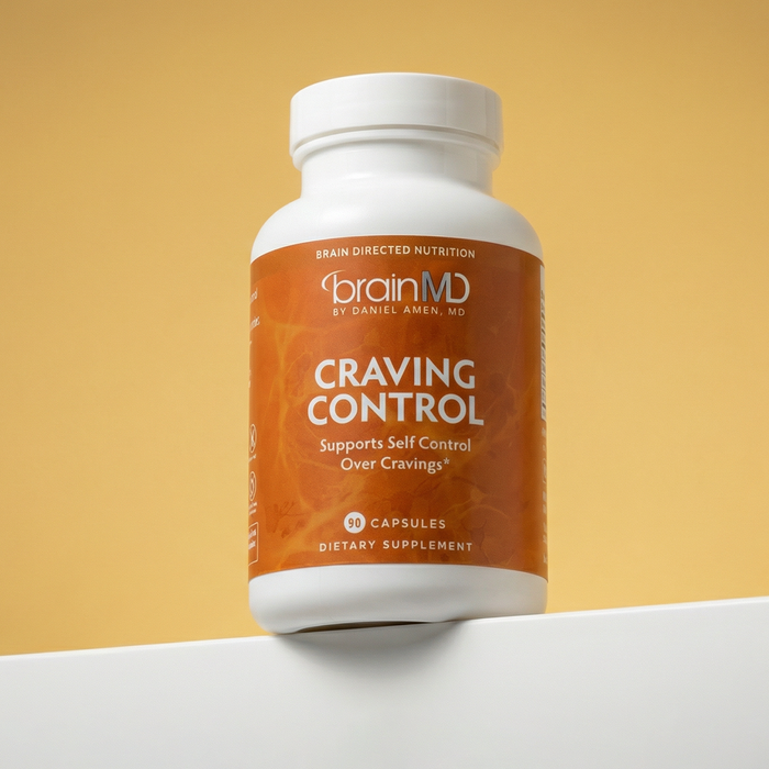 Orange supplement bottle against a goldenrod background.