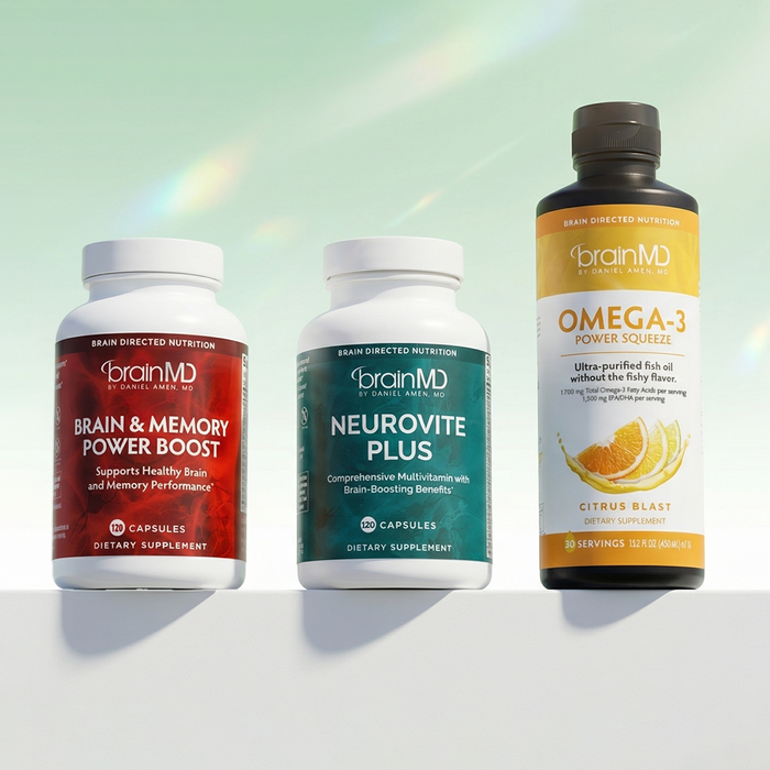 Two short and one tall supplement bottle against a mint green background.
