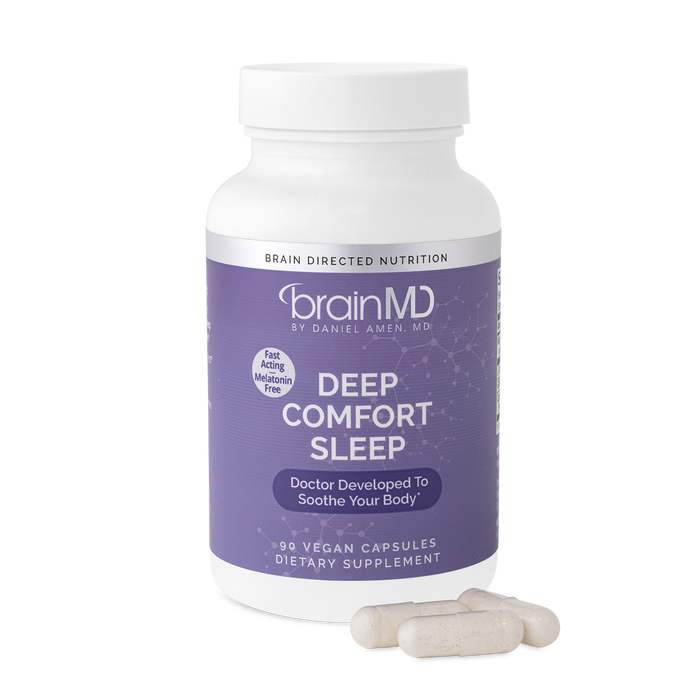 BrainMD Deep Comfort Sleep: purple supplement bottle with capsules at the base against a transparent background