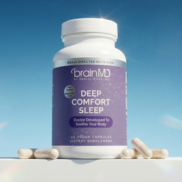 Purple supplement bottle with white capsules at the base against a blue background.