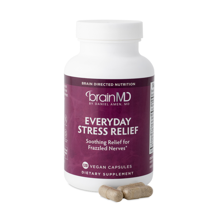 BrainMD Everyday Stress Relief: purple supplement bottle with capsules against a transparent background