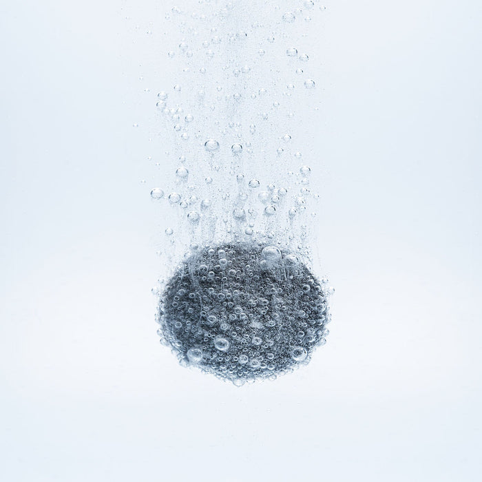 BrainMD H2 Boost Molecular Hydrogen: gray tablet dissolving in water, white background