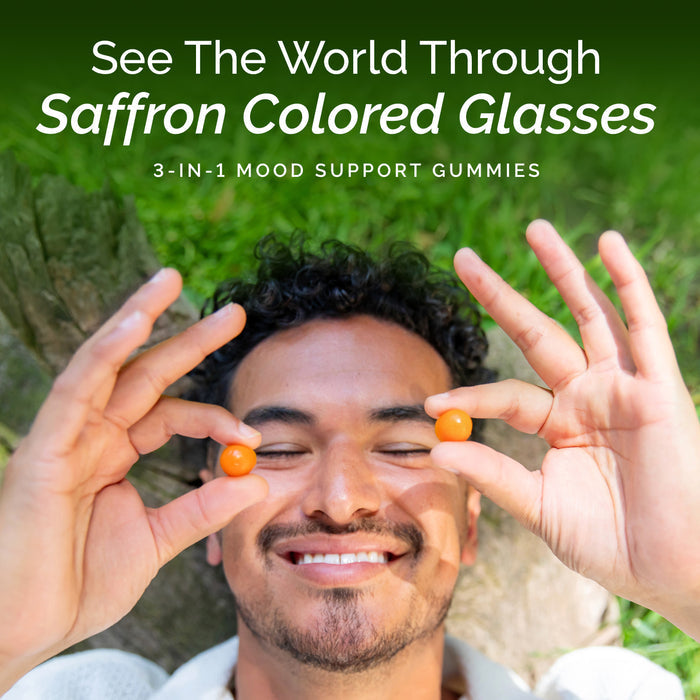 Man holding saffron-colored gummies with text about mood support gummies by Dr. Daniel Amen.