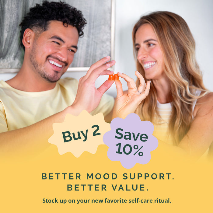 Man and woman holding a small object with promotional text overlay: Buy 2, Save 10%