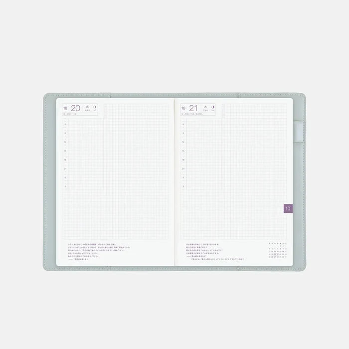 The cover wrapped around an open A5 Cousin techo, showing a daily spread