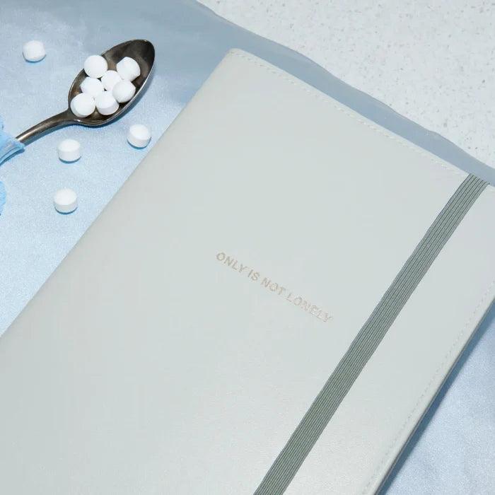 A close-up of the cover with a spoonful of little white ramune sweets above it