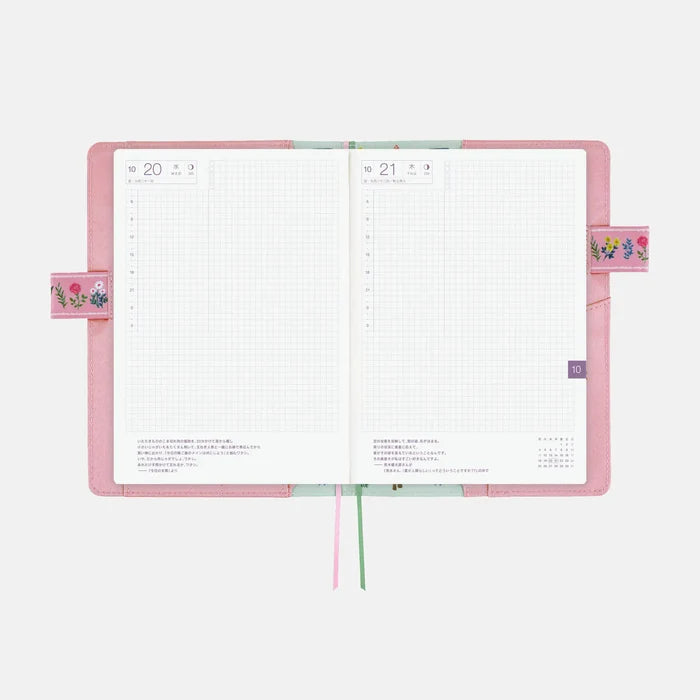 The cover wrapped around an open A5 Cousin techo, pink edges showing at the sides
