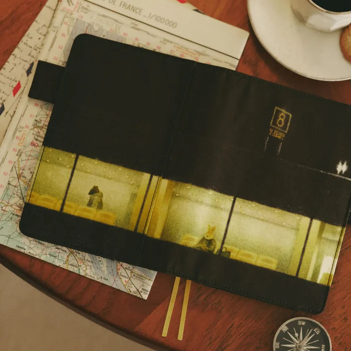 The cover opened out across a map, a compass and a cup of coffee alongside