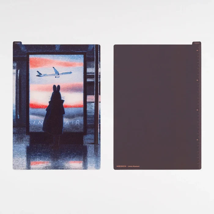 The In the Air board itself: a figure at a window watching an aeroplane cross a dusk sky, and the deep midnight navy reverse