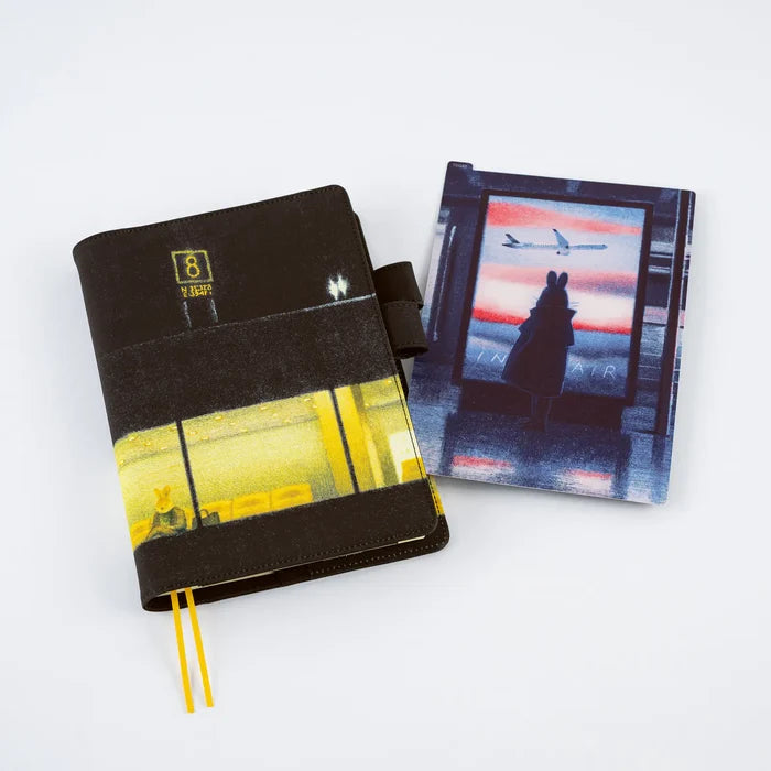 A covered techo book with the In the Air pencil board standing beside it