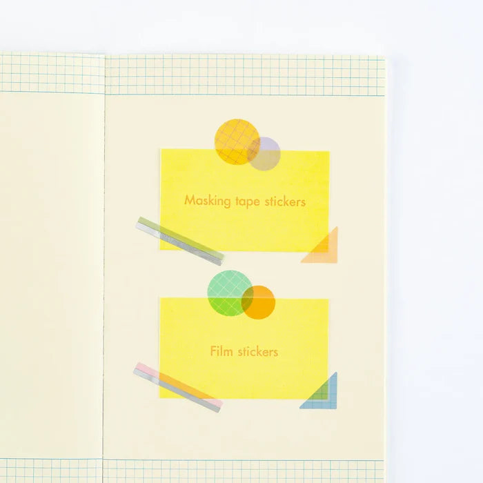 A sample page showing both sticker types in use — masking-tape strips and file stickers holding paper in place