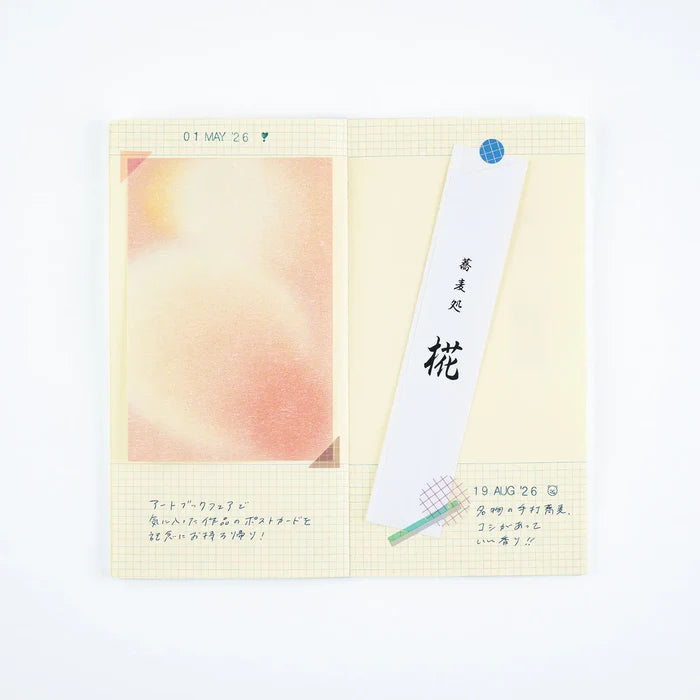 A techo page with a soft pink photograph and a labelled paper slip taped into place