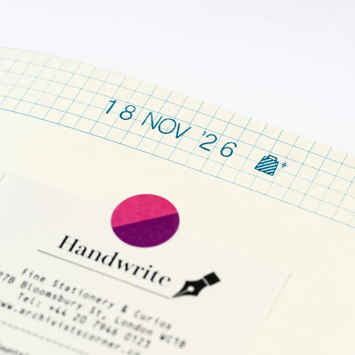 A page stamped 18 NOV '26 above a pasted-in business card and a magenta dot sticker