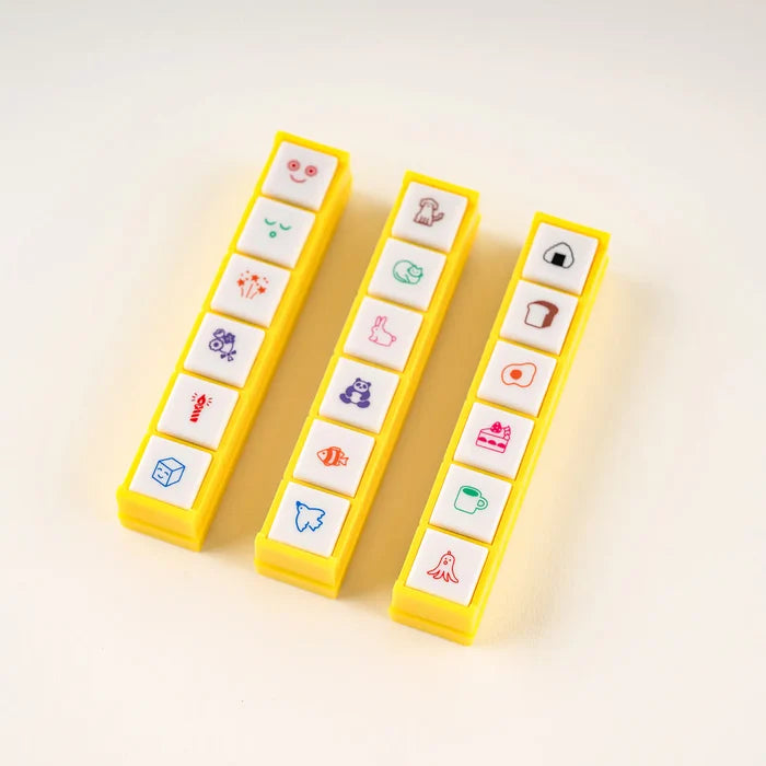 Three of the stamp bars standing upright, each holding a different set of six motifs