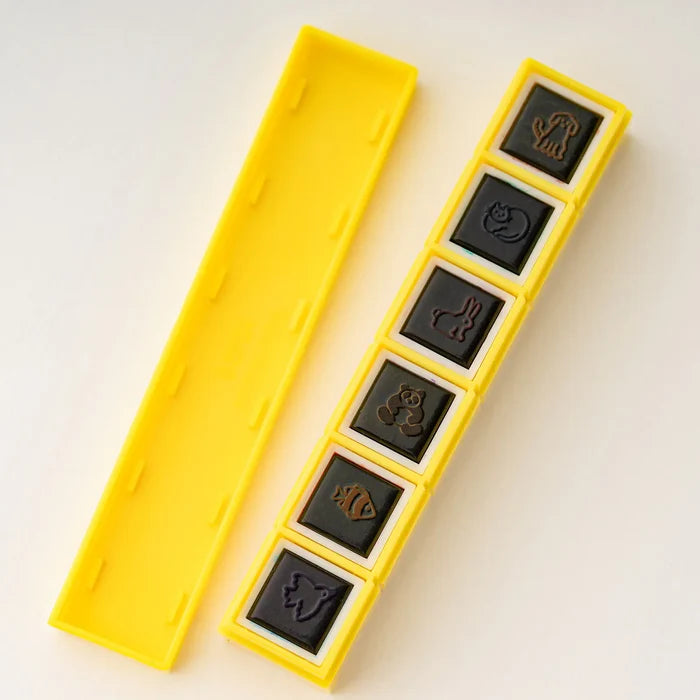 The underside of the bar, the six black rubber stamp faces set in a row