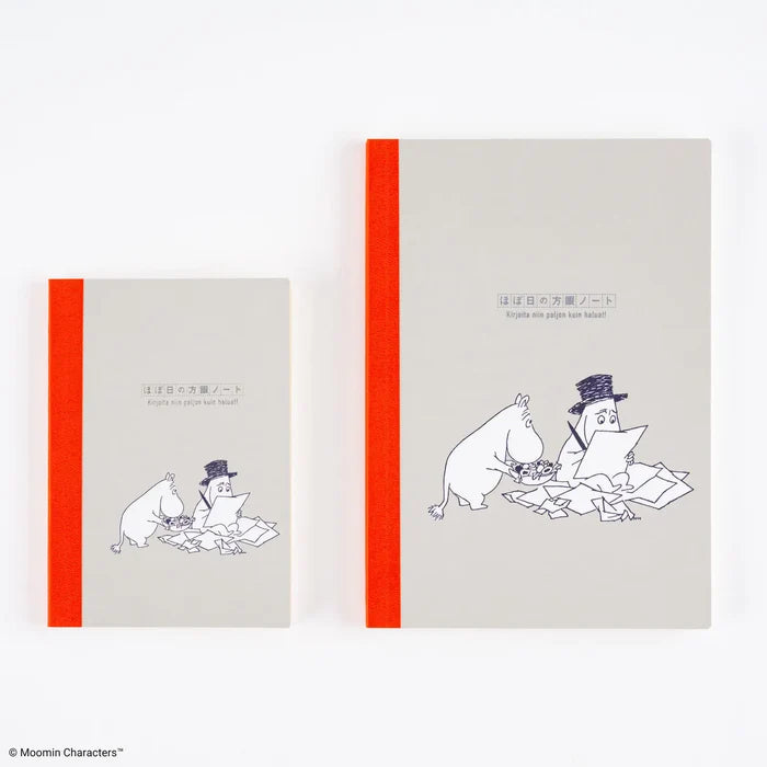 Moomin Hobonichi Graph Notebook (A5): the A5 and A6 notebooks side by side — the A5 is the larger one on the right, grey card with an orange spine and a line drawing of Moomin among scattered papers