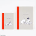 Moomin Hobonichi Graph Notebook (A5): the A5 and A6 notebooks side by side — the A5 is the larger one on the right, grey card with an orange spine and a line drawing of Moomin among scattered papers
