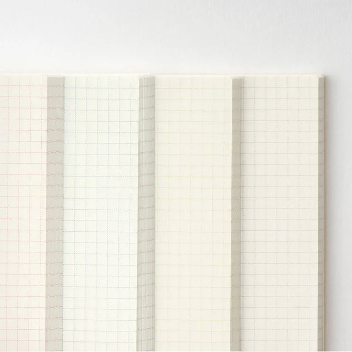 Several notebooks fanned open, showing the fine graph ruling throughout
