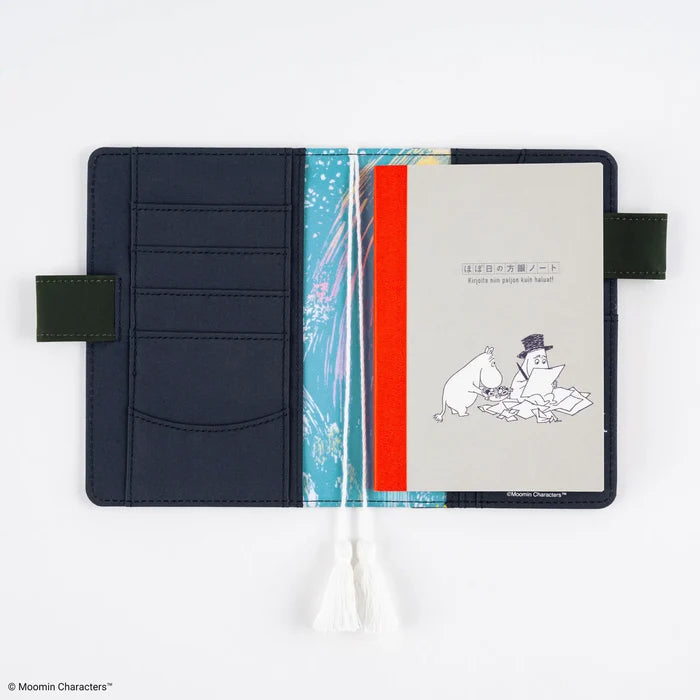 The notebook held in a navy techo cover, tucked in beside the cover's pockets