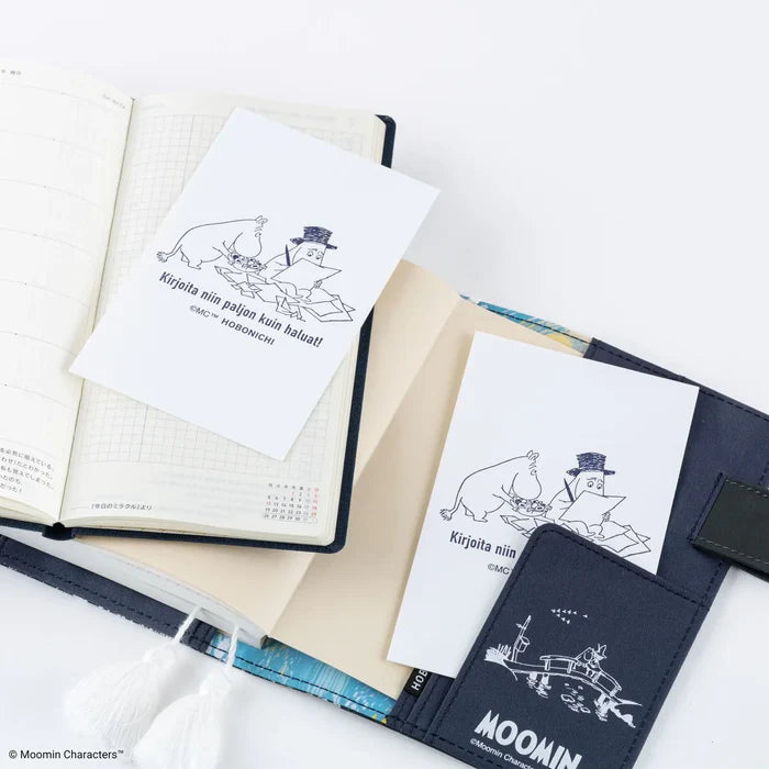 Several sheets spread across a desk with a techo, a pen and a Moomin pouch