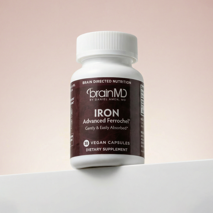 Brown supplement bottle against an off-white background.