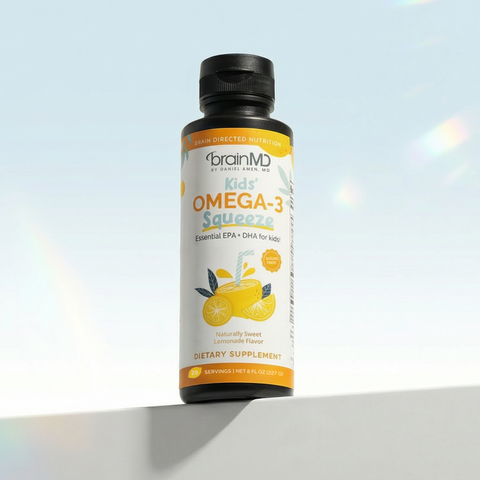 Tall orange liquid supplement bottle against a powder blue background.