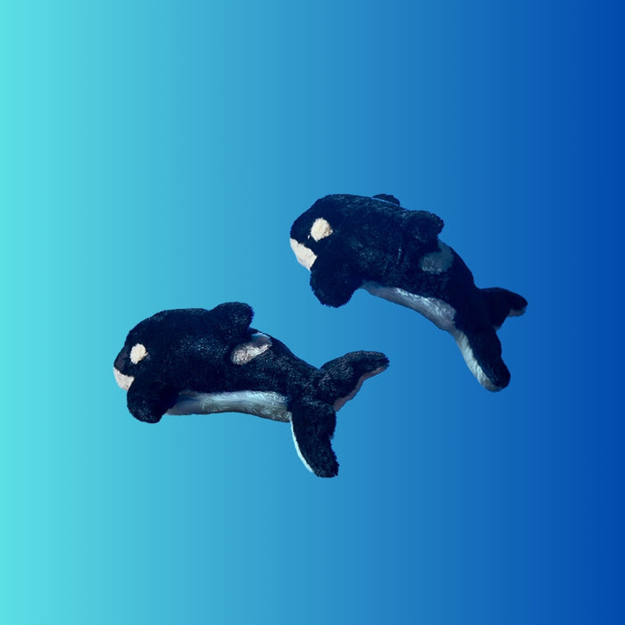 Blue killer whale Pouzoo animal design cushion pouch against a blue background.