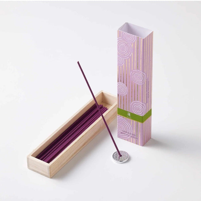 Kousaido Hyakurakukou incense sticks placed with a matching incense holder.