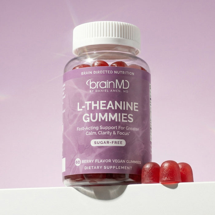 Purple supplement bottle with 3 dark red gummies at the base against a light purple background.