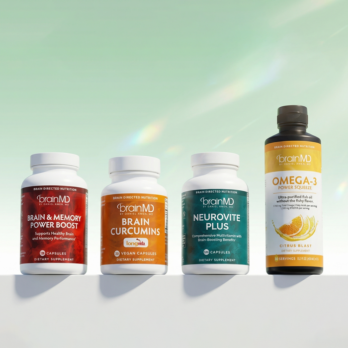 3 short supplement bottles and 1 tall supplement bottle against a mint green background.