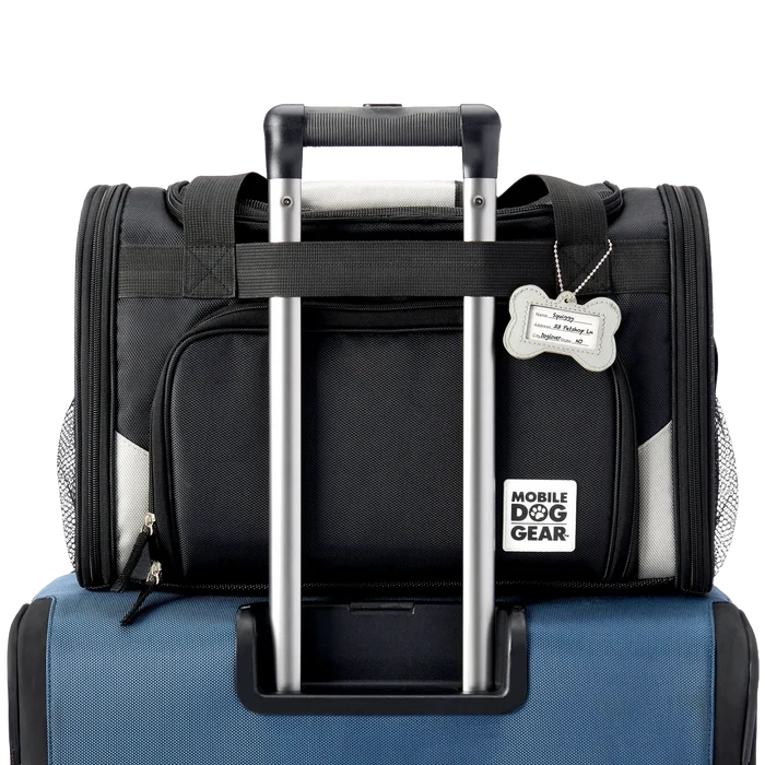 Mobile Dog Gear Pet Carrier Plus,"Black pet carrier attached to luggage handle with bone-shaped ID tag"