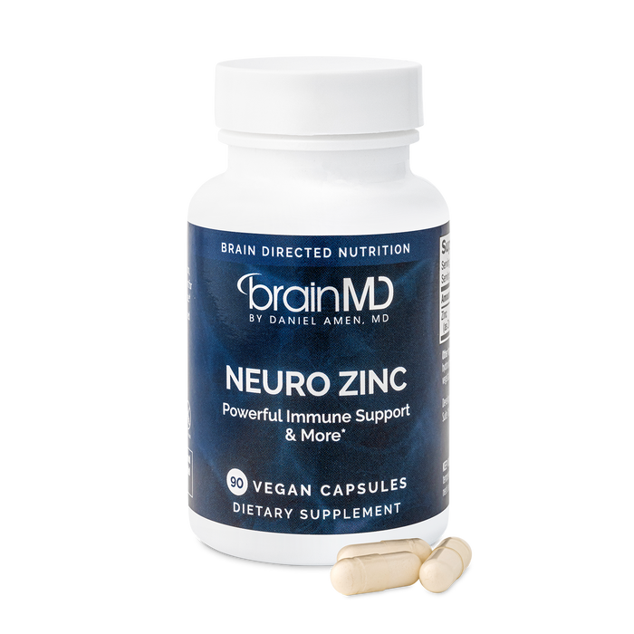 BrainMD Neuro Zinc: image of gray supplement bottle and three off-white capsules at its base with transparent background