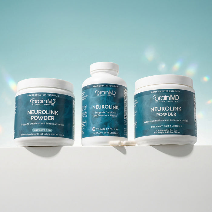 One supplement bottle and two tubs of supplement powder against a powder blue background.