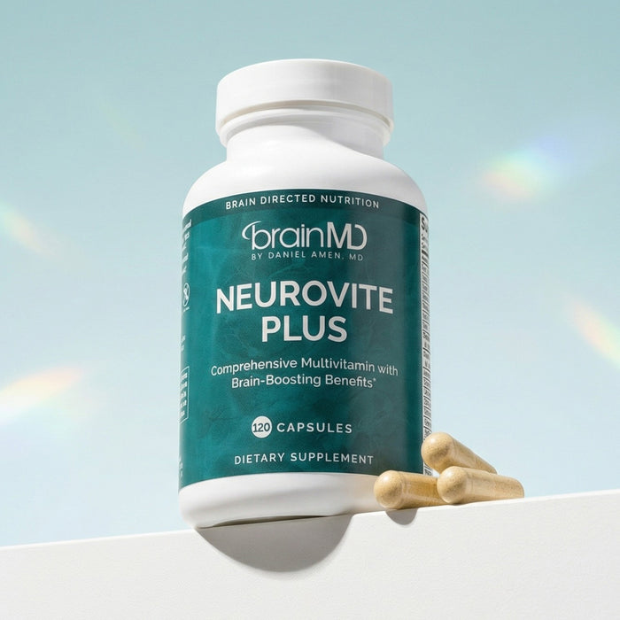 Green supplement bottle with capsules at the base against a powder blue background.