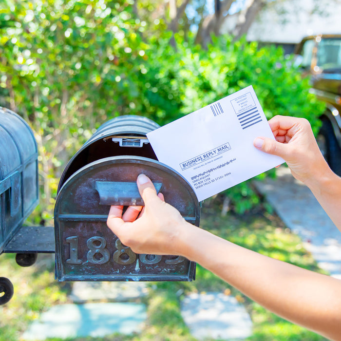 Mailing a BrainMD at-home test kit sample to the OmegaQuant lab in the prepaid business reply envelope