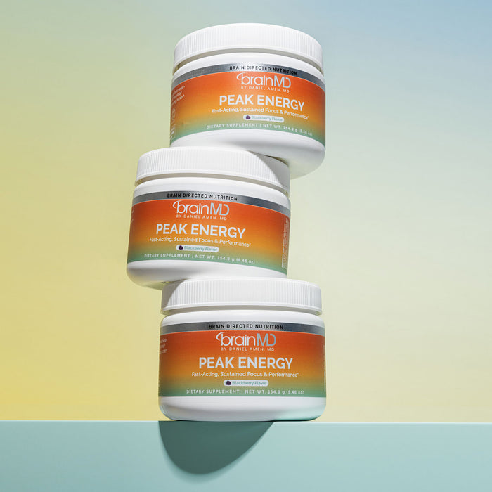 Three stacked supplement containers against a light yellow background.
