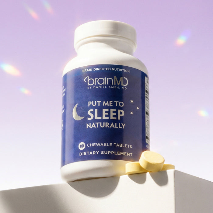 Blue supplement bottle with orange tablets at the base against a light purple background.