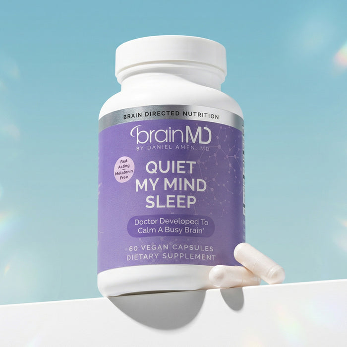 Purple supplement bottle with white capsules at the base against a light blue background.