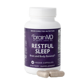 BrainMD Restful Sleep: purple supplement bottle with capsules against a transparent background