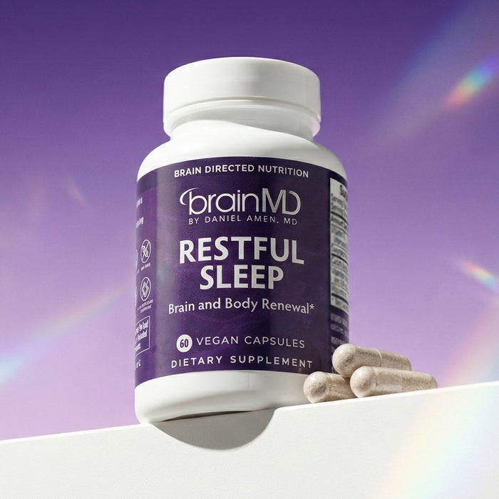 Dark purple supplement bottle with white capsules at the base against a light purple background.
