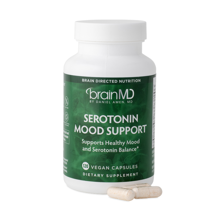 BrainMD Serotonin Mood Support: green supplement bottle with capsules at the base against a transparent background