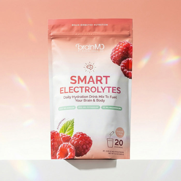 Bag of individual powder packets against a peach-colored background.